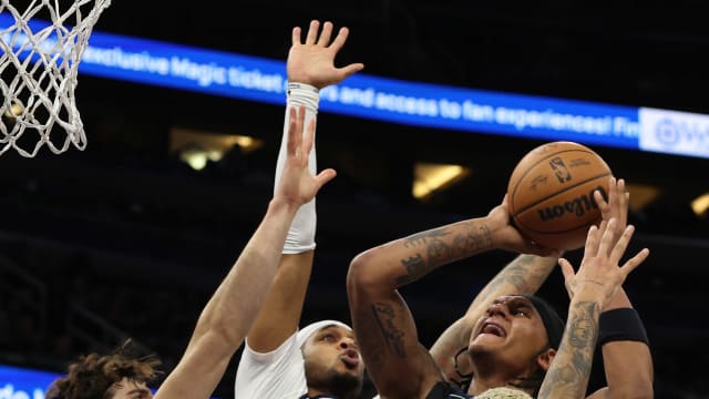 Orlando Magic forward Paolo Banchero (5) shoots as forward Deni Avdija (8), forward Kyle Kuzma (33) and Washington Wizards center Daniel Gafford (21) defend during the second quarter at Amway Center.